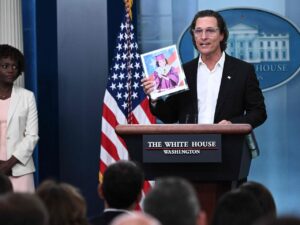Matthew Holding A Photo Of A Gun Shooting During His Speech At The White House