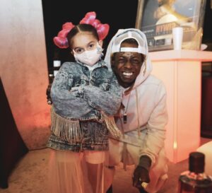 A Photo Of Taylen With Rapper Lil Wayne Who Signed Her Under His Young Money Record Label.